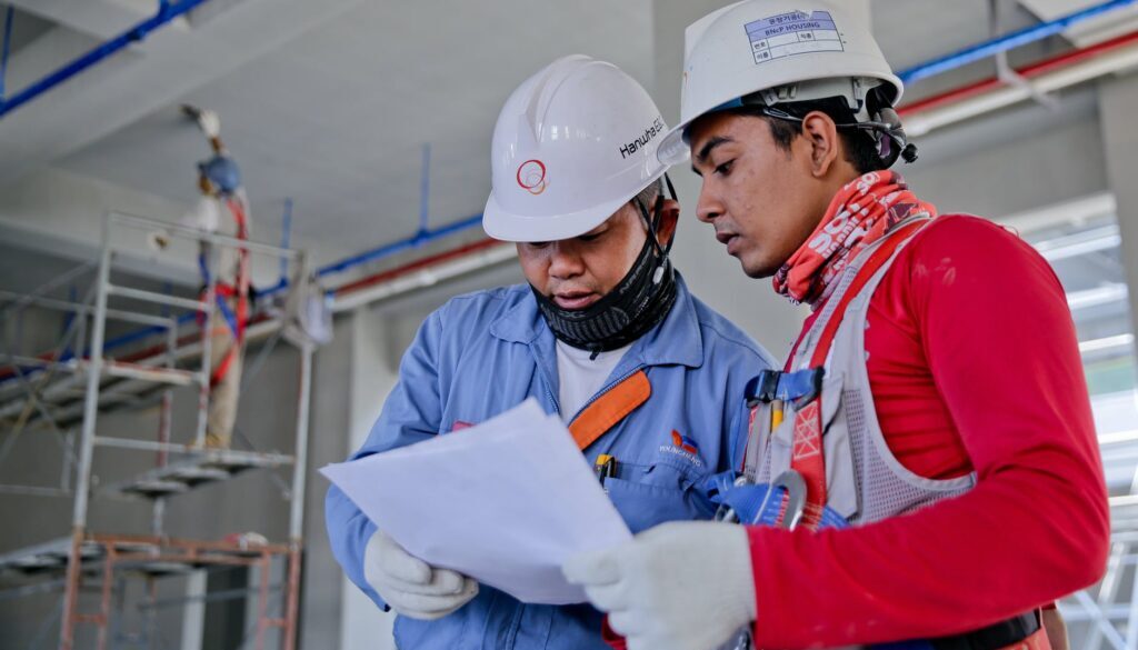 two man holding white paper