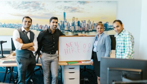 people standing beside a whiteboard