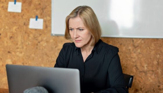 woman in black long sleeve shirt using a laptop